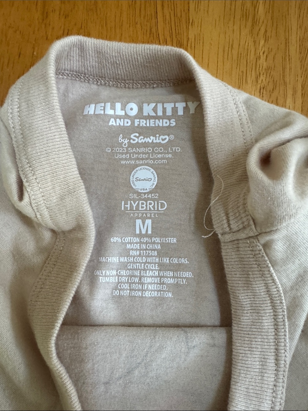 Hello Kitty Beige Graphic T-shirt Tee with Pink Bow and Blue Outfit - Picture 4 of 6